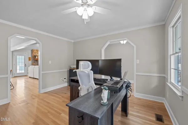 a view of a workspace with furniture and wooden floor