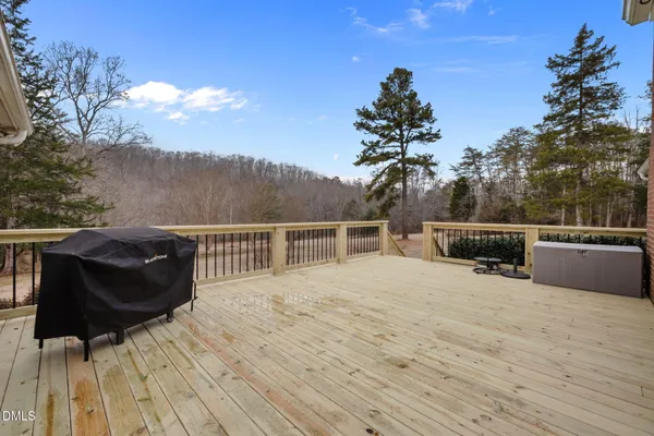 a terrace of a house with wooden floor and outdoor seating
