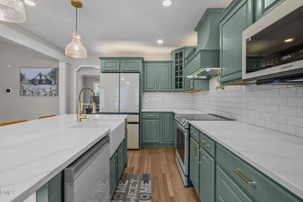 a kitchen with a sink and a stove top oven