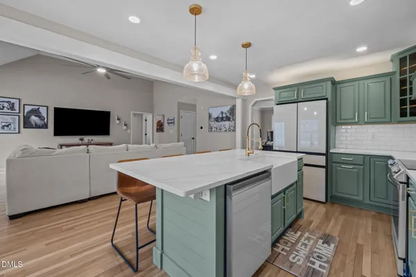 a kitchen with a stove a sink and a refrigerator