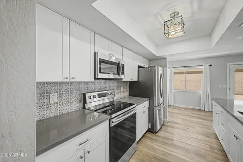 a kitchen with a refrigerator stove and microwave
