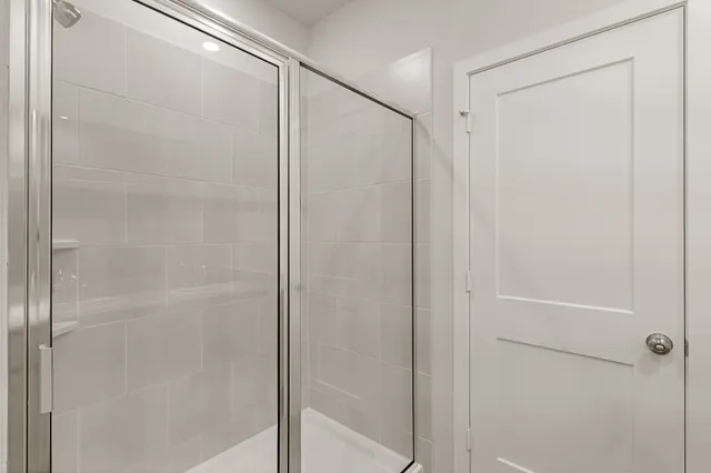 a bathroom with a glass shower door