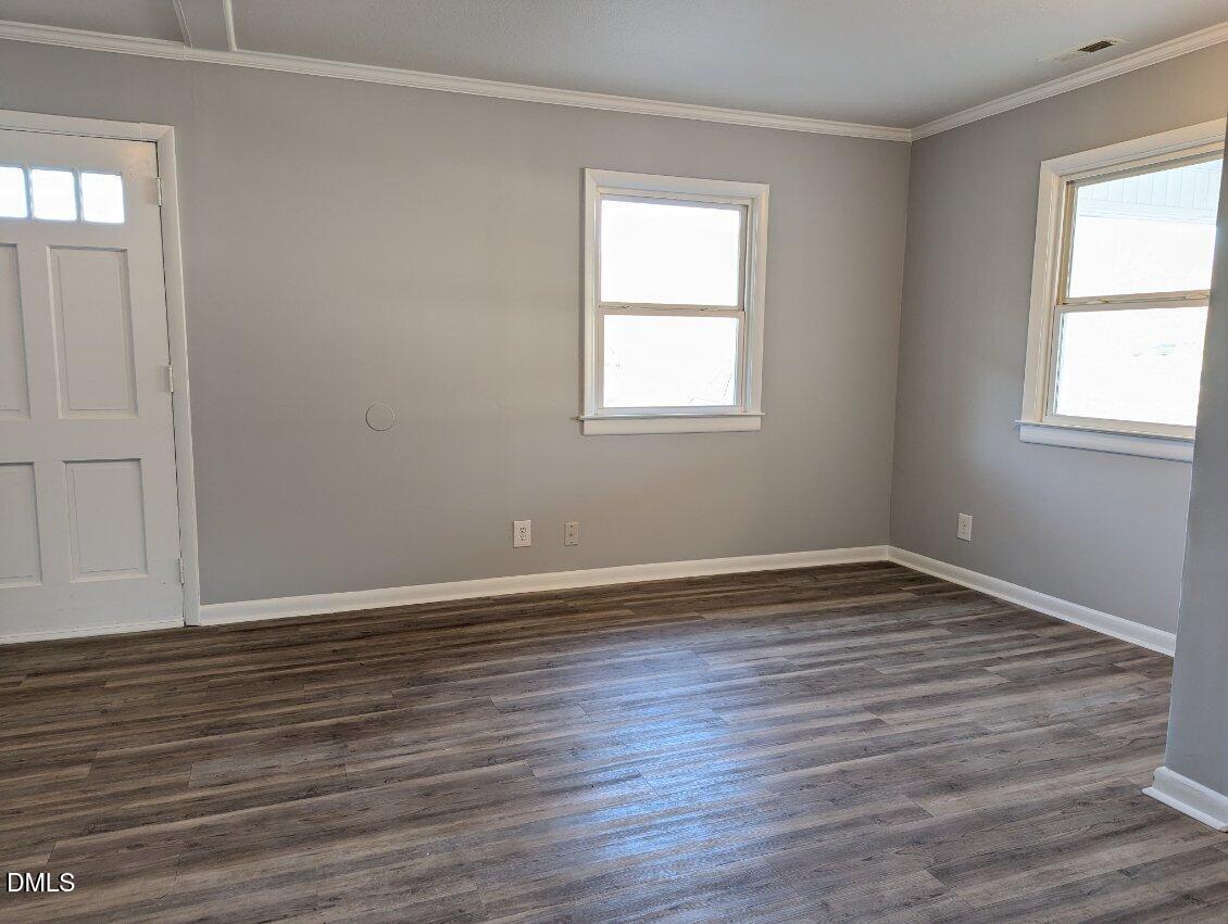 303 Stancil Street Smithfield, NC 27577 - Photo 5 of 13 a view of an empty room with wooden floor and a window