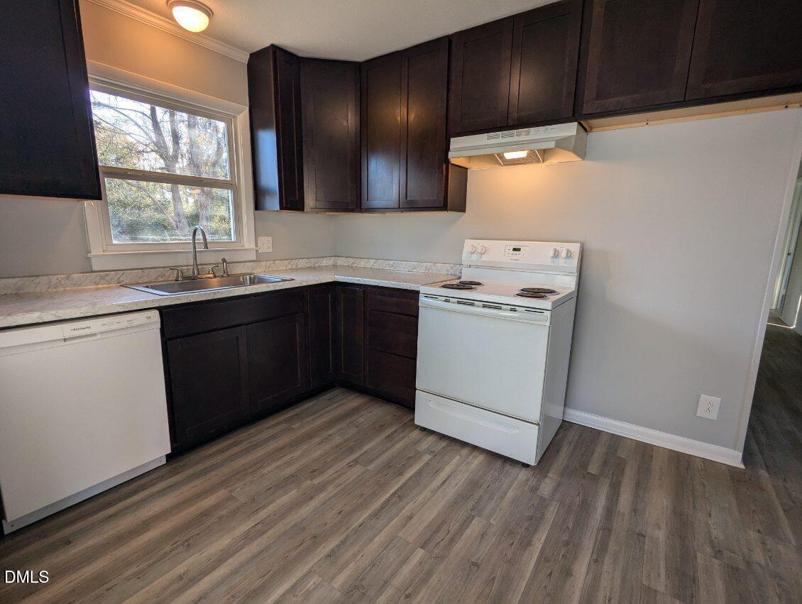 303 Stancil Street Smithfield, NC 27577 - Photo 8 of 13 a kitchen with a sink a stove and cabinets