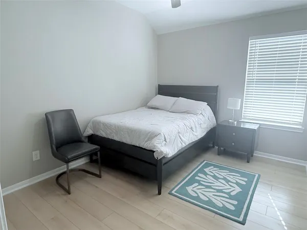 a bedroom with a bed and a chair