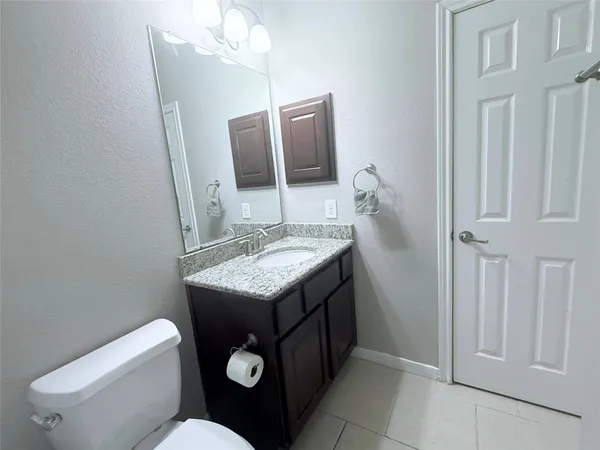 a bathroom with a glass shower door and a sink