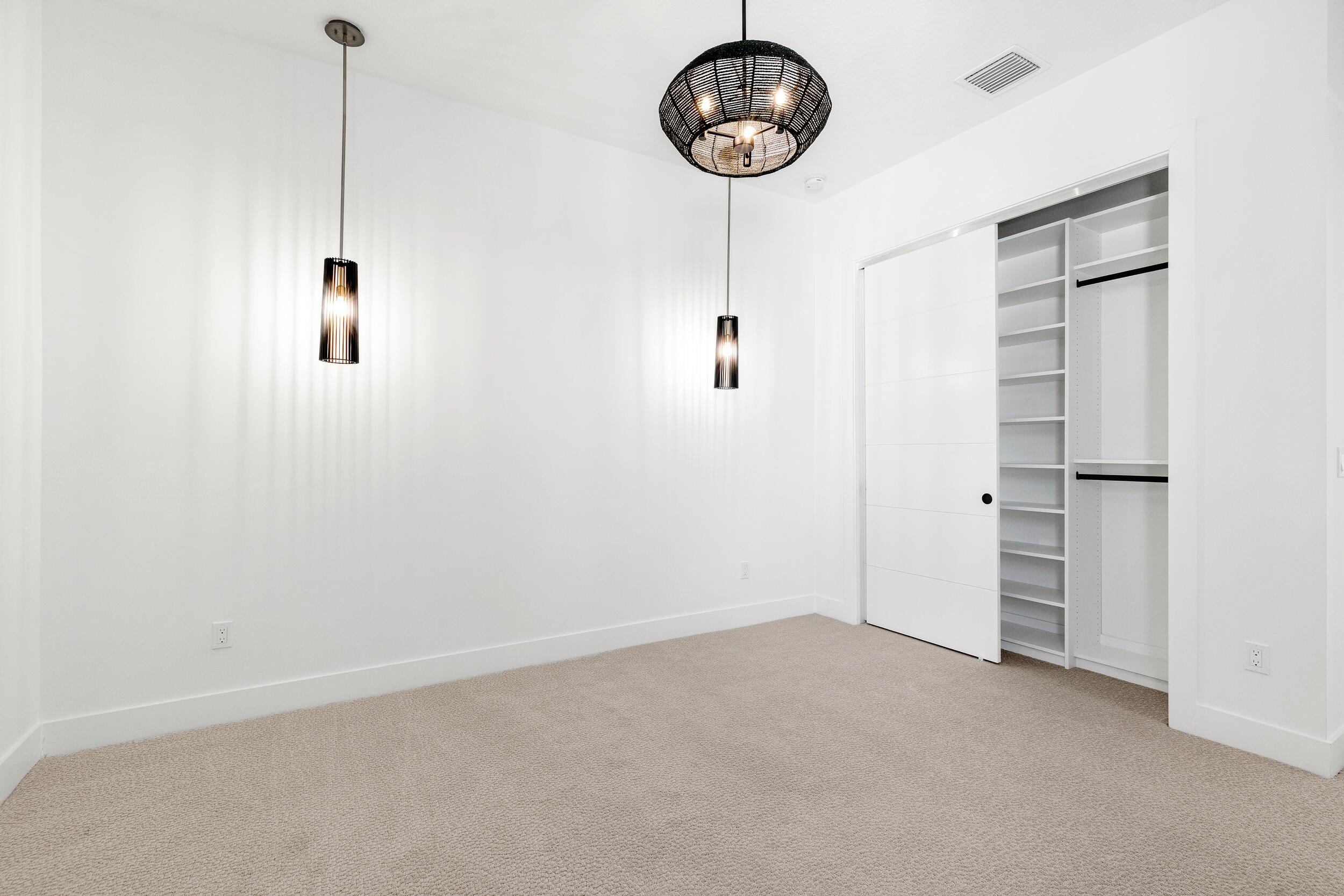 9893 Espresso Manor Boca Raton, FL 33496 - Photo 13 of 71 a view of a room with racks on the wall