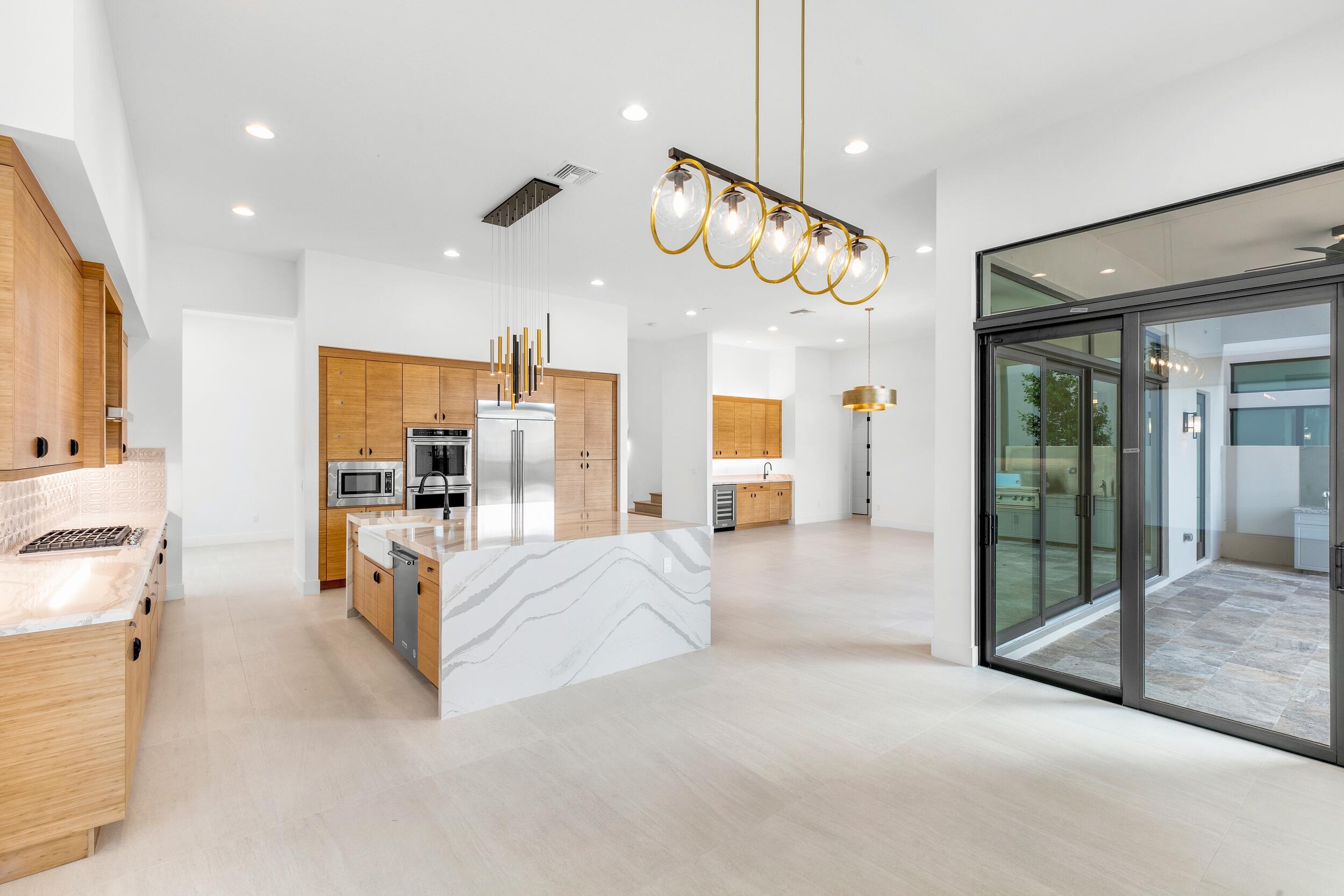 9893 Espresso Manor Boca Raton, FL 33496 - Photo 17 of 71 a large bedroom with a large bed and chandelier