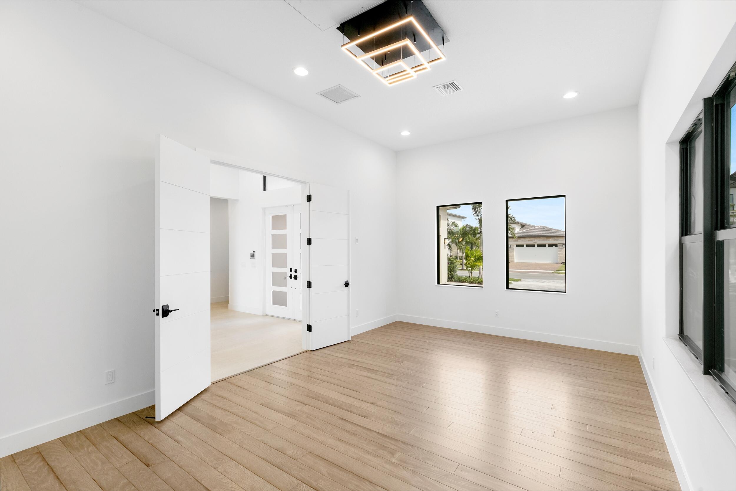 9893 Espresso Manor Boca Raton, FL 33496 - Photo 22 of 71 wooden floor in an empty room with a window