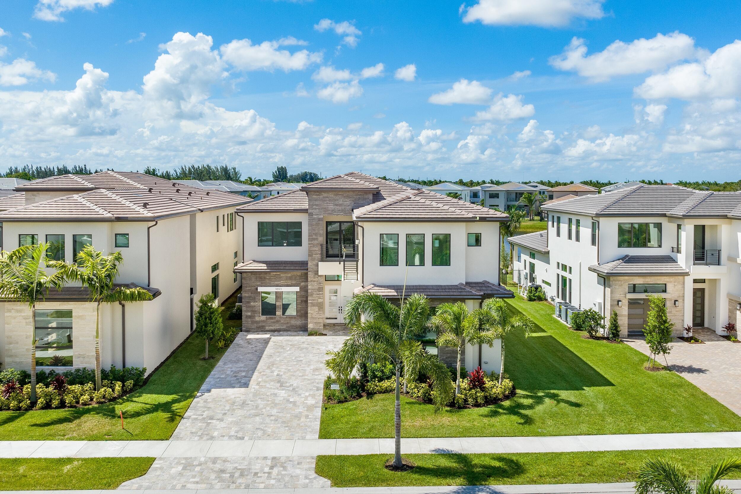 9893 Espresso Manor Boca Raton, FL 33496 - Photo 3 of 71 a front view of a house with a yard