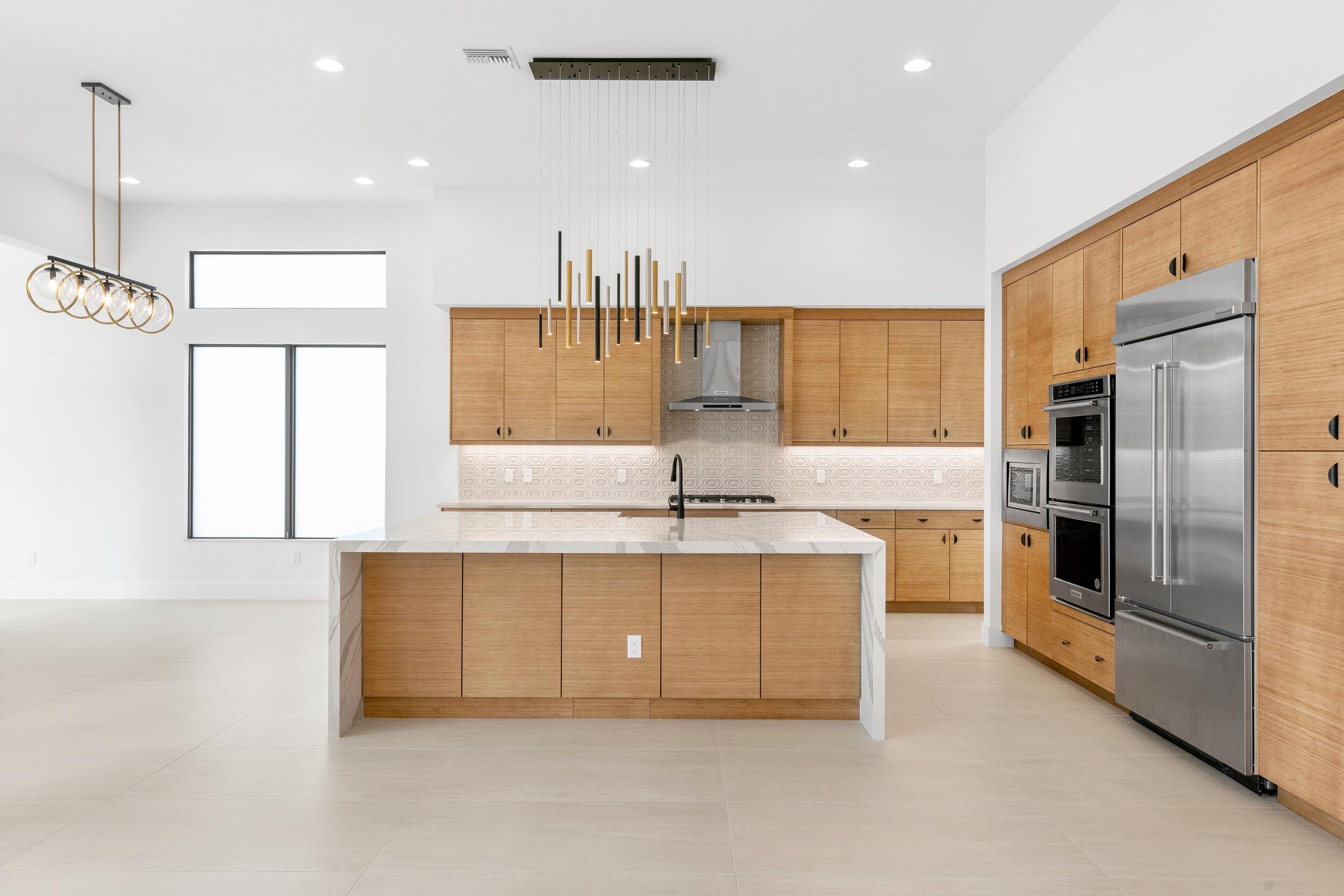 9893 Espresso Manor Boca Raton, FL 33496 - Photo 36 of 71 a large kitchen with stainless steel appliances kitchen island granite countertop a large counter top stainless steel appliances and cabinets