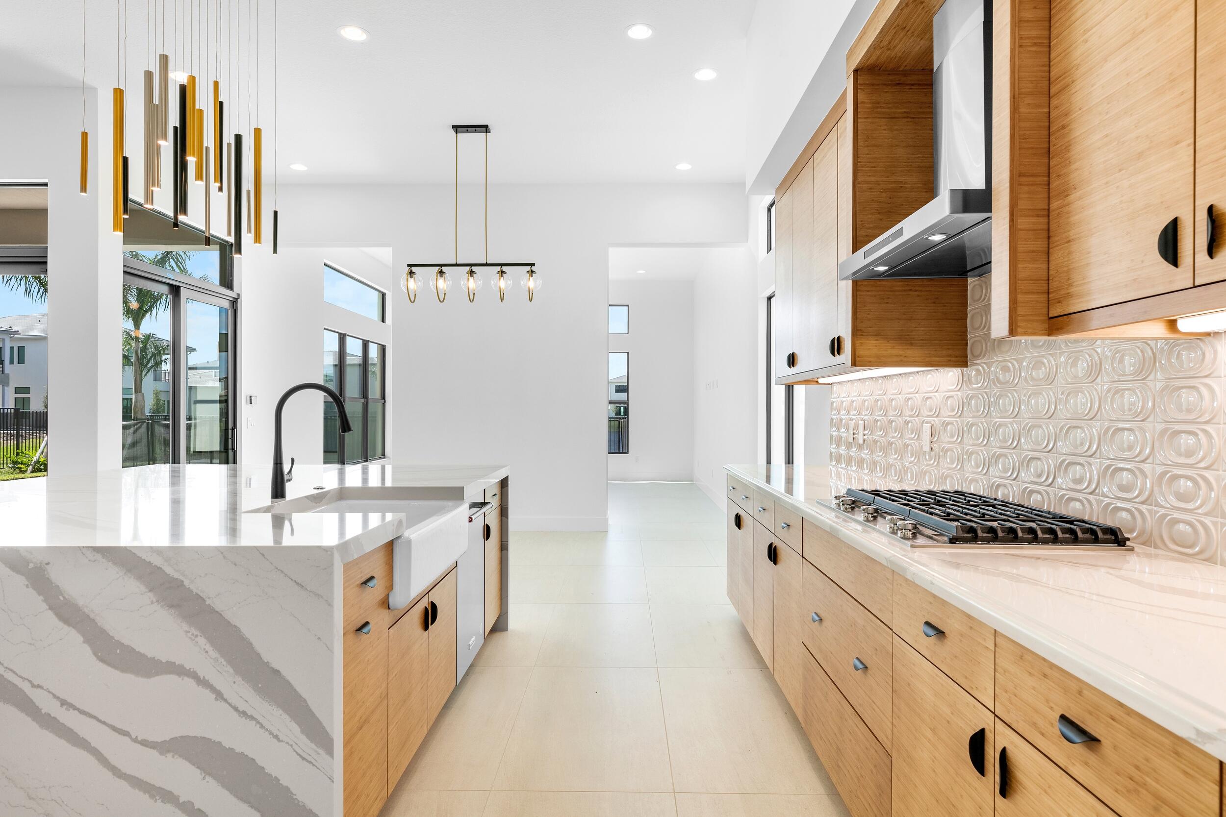 9893 Espresso Manor Boca Raton, FL 33496 - Photo 40 of 71 a kitchen with stainless steel appliances granite countertop a stove a sink and a refrigerator