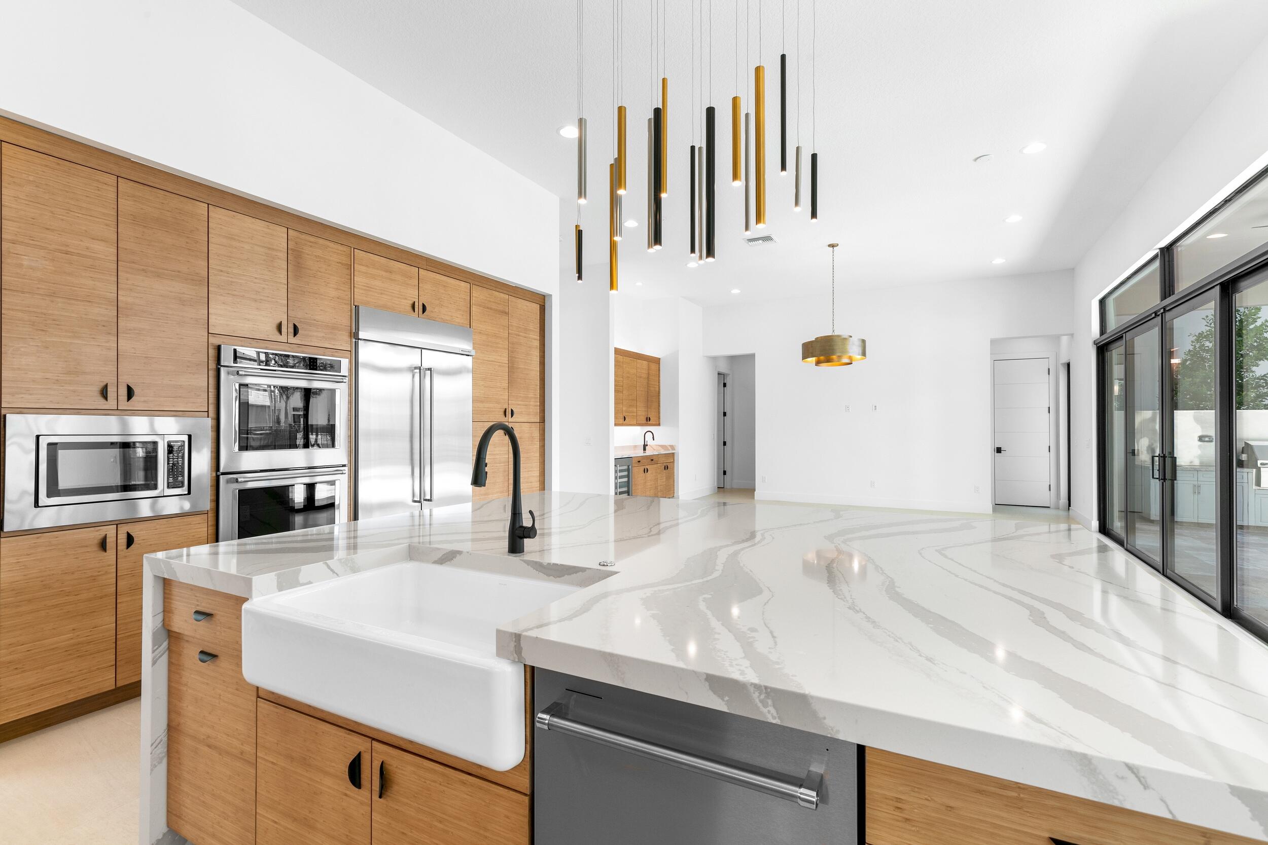 9893 Espresso Manor Boca Raton, FL 33496 - Photo 42 of 71 a kitchen with stainless steel appliances granite countertop a sink and cabinets