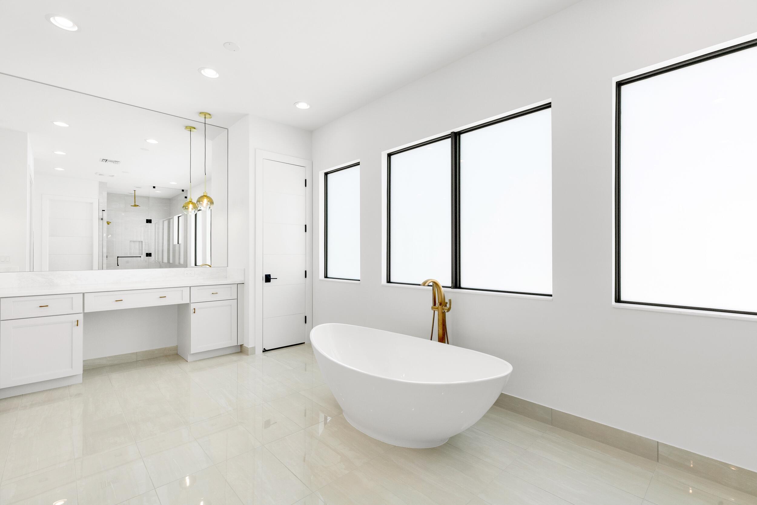 9893 Espresso Manor Boca Raton, FL 33496 - Photo 59 of 71 a bathroom with a double vanity sink a mirror and a bathtub