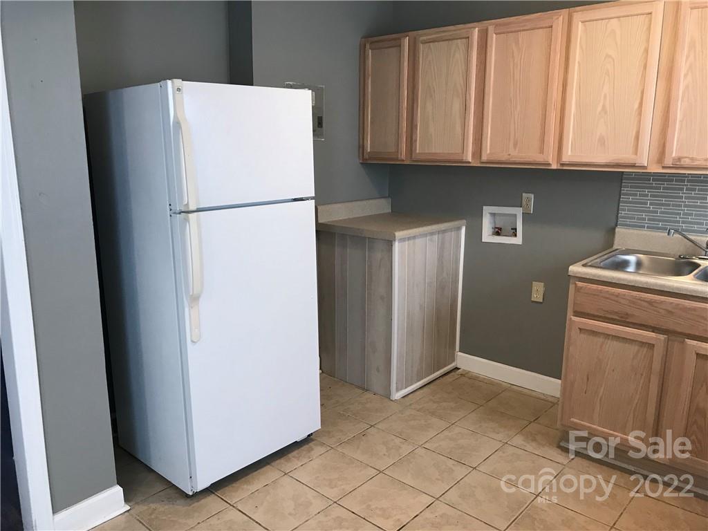 334 North Hoskins Road Charlotte, NC 28216 - Photo 2 of 18 a white refrigerator freezer and a stove sitting inside of a kitchen