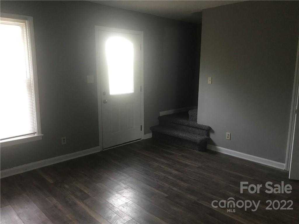 334 North Hoskins Road Charlotte, NC 28216 - Photo 6 of 18 an empty room with wooden floor and windows