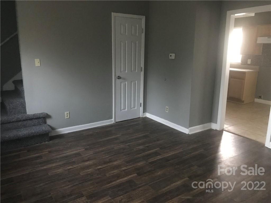 334 North Hoskins Road Charlotte, NC 28216 - Photo 7 of 18 an empty room with wooden floor and windows