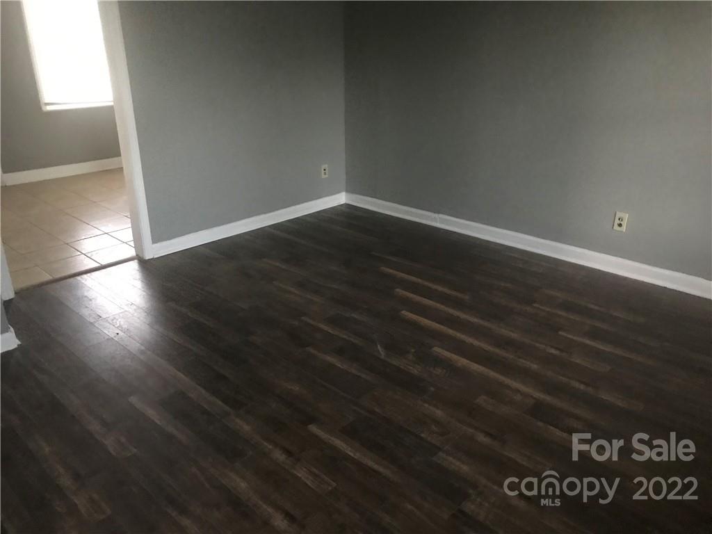 334 North Hoskins Road Charlotte, NC 28216 - Photo 8 of 18 an empty room with wooden floor