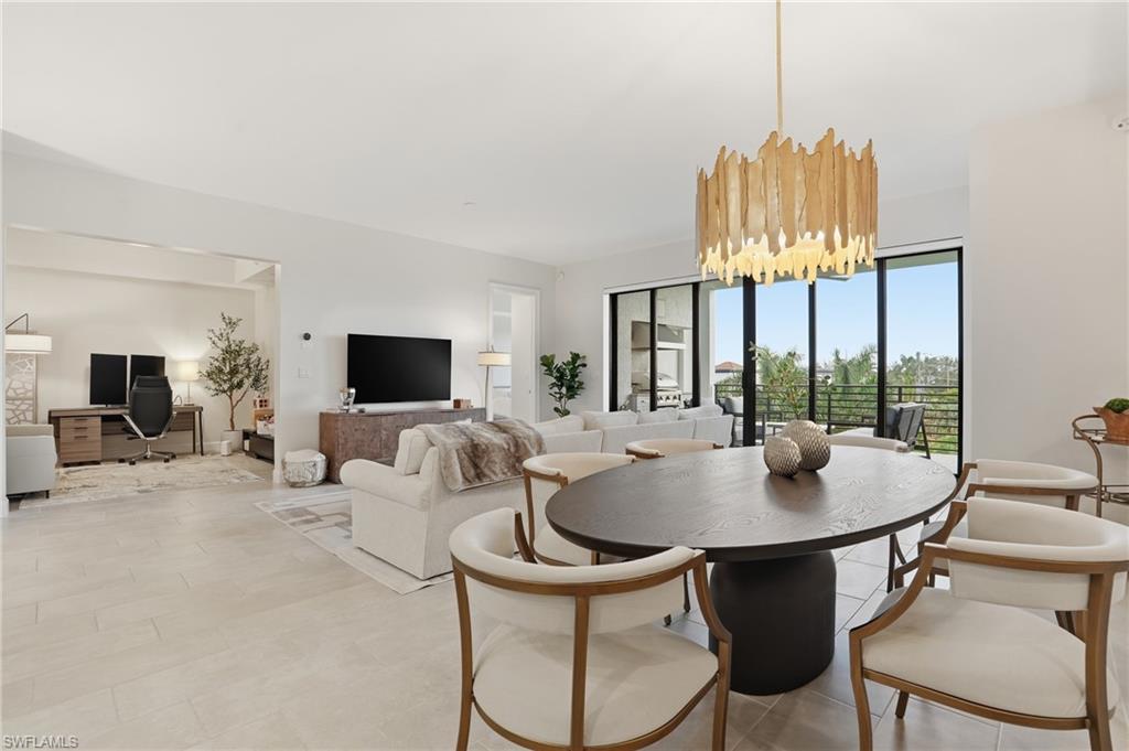 1125 Central Avenue, Unit 469 Naples, FL 34102 - Photo 11 of 38 a living room with furniture and a flat screen tv