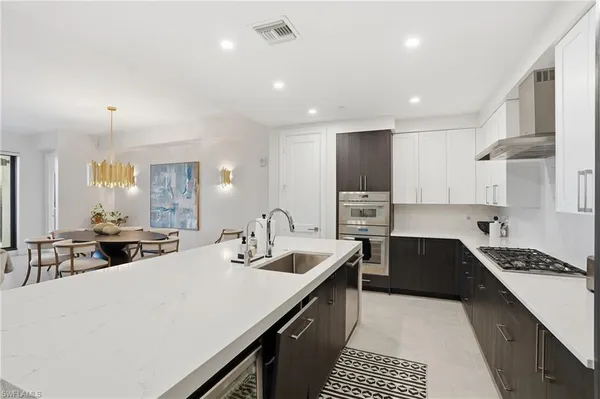 a kitchen with a sink a stove and cabinets
