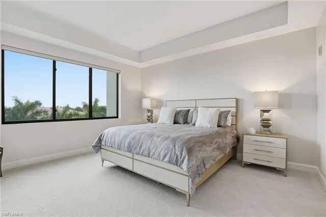 a bedroom with a bed lamp and window