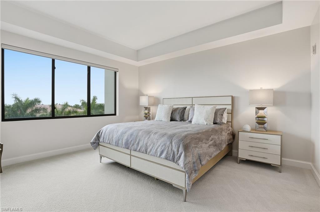 1125 Central Avenue, Unit 469 Naples, FL 34102 - Photo 19 of 38 a bedroom with a bed lamp and window