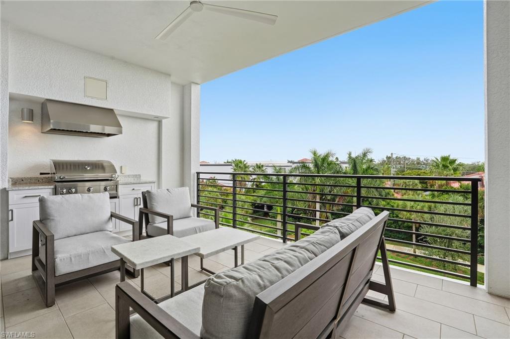 1125 Central Avenue, Unit 469 Naples, FL 34102 - Photo 2 of 38 a roof deck with couches and wooden floor