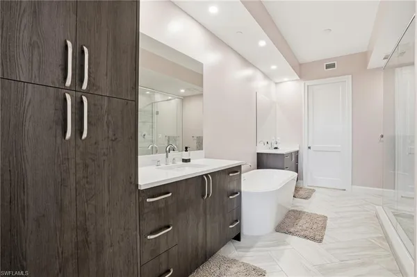 a bathroom with a double vanity sink toilet and mirror