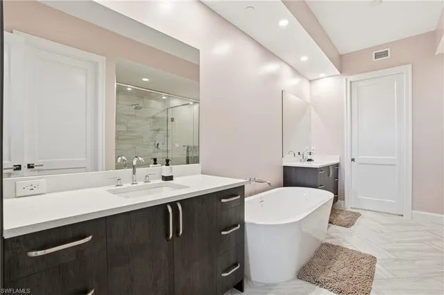a bathroom with a double vanity sink toilet and a mirror