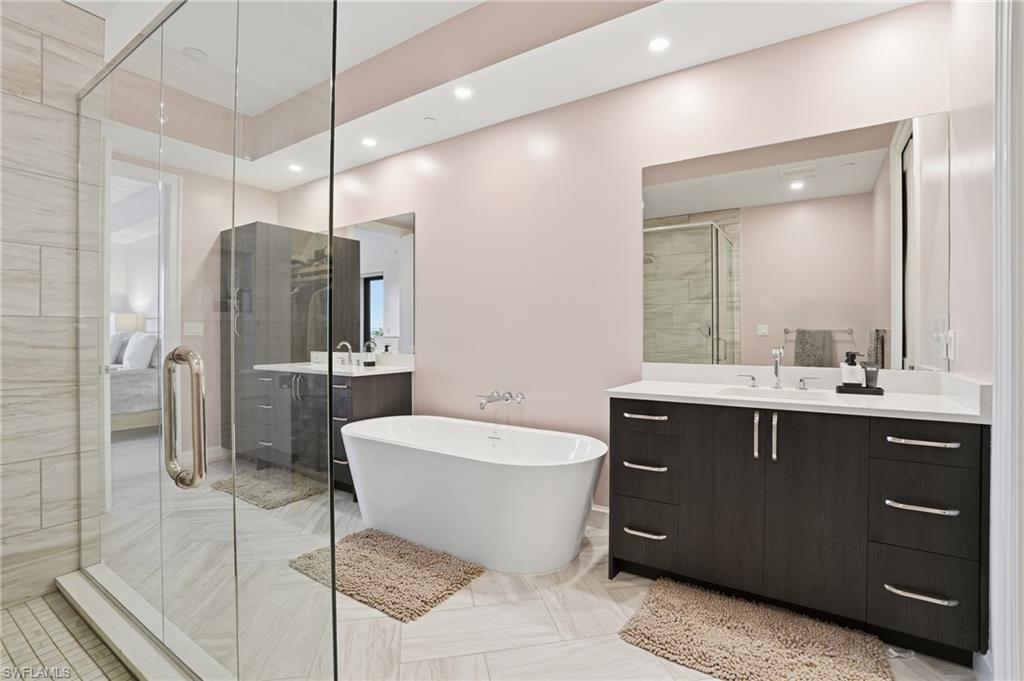 1125 Central Avenue, Unit 469 Naples, FL 34102 - Photo 24 of 38 a spacious bathroom with a bathtub shower sink mirror and toilet