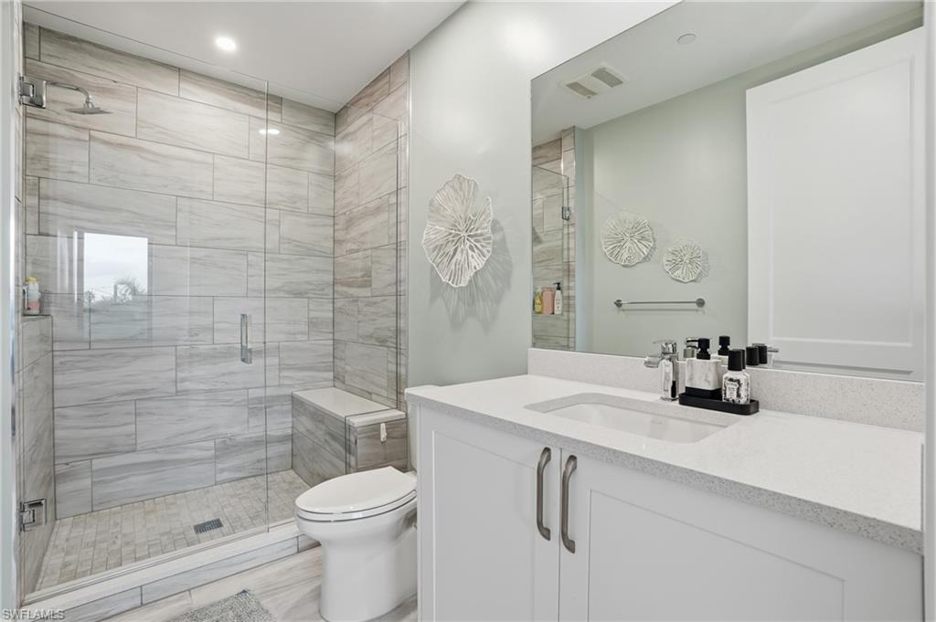 1125 Central Avenue, Unit 469 Naples, FL 34102 - Photo 28 of 38 a bathroom with a sink a toilet and shower