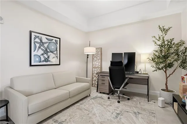 a view of a livingroom with workspace and a couch
