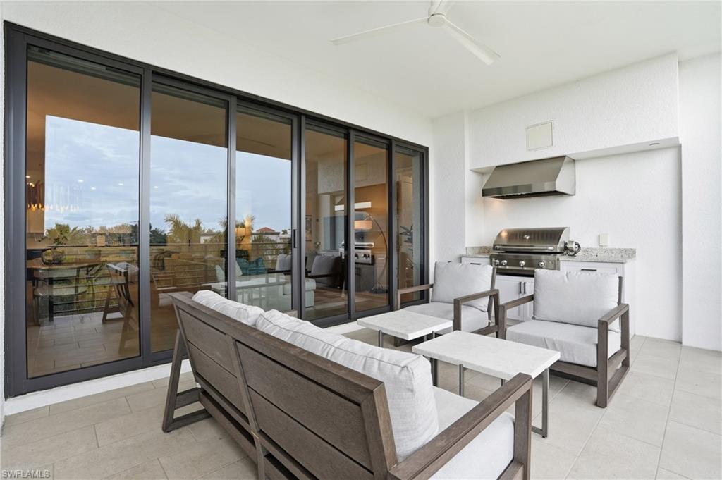 1125 Central Avenue, Unit 469 Naples, FL 34102 - Photo 34 of 38 a living room with furniture and a large window