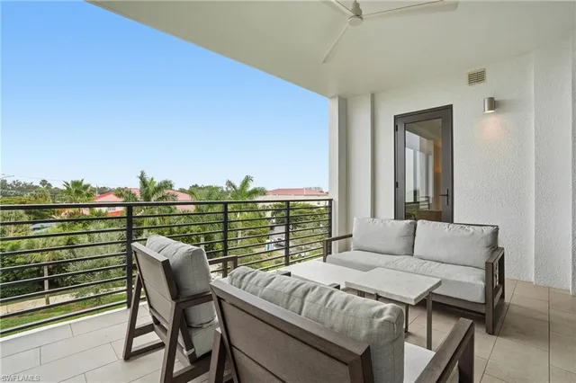 a balcony with a table and chairs