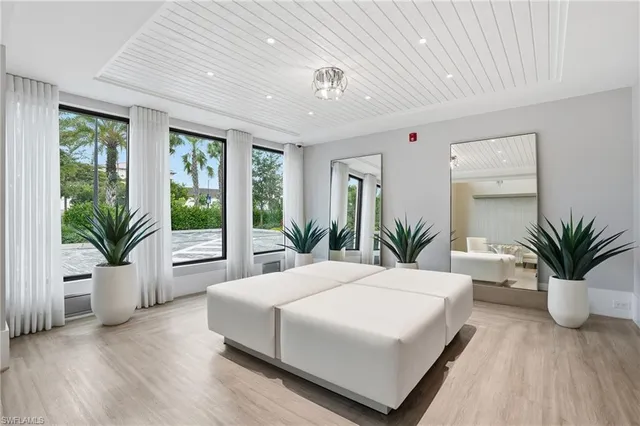 a bedroom with a large bed and a large window