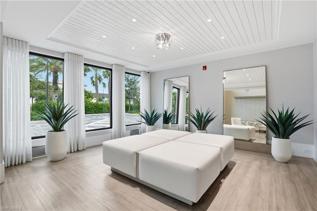 1125 Central Avenue, Unit 469 Naples, FL 34102 - Photo 37 of 38 a bedroom with a large bed and a large window