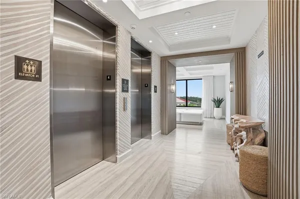 a view of a hallway with wooden floor and furniture