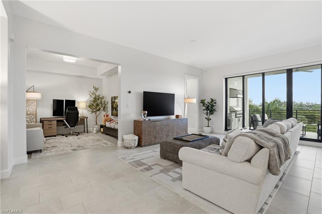 1125 Central Avenue, Unit 469 Naples, FL 34102 - Photo 5 of 38 a living room with furniture and a flat screen tv