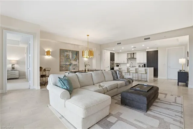 a living room with furniture and view of kitchen