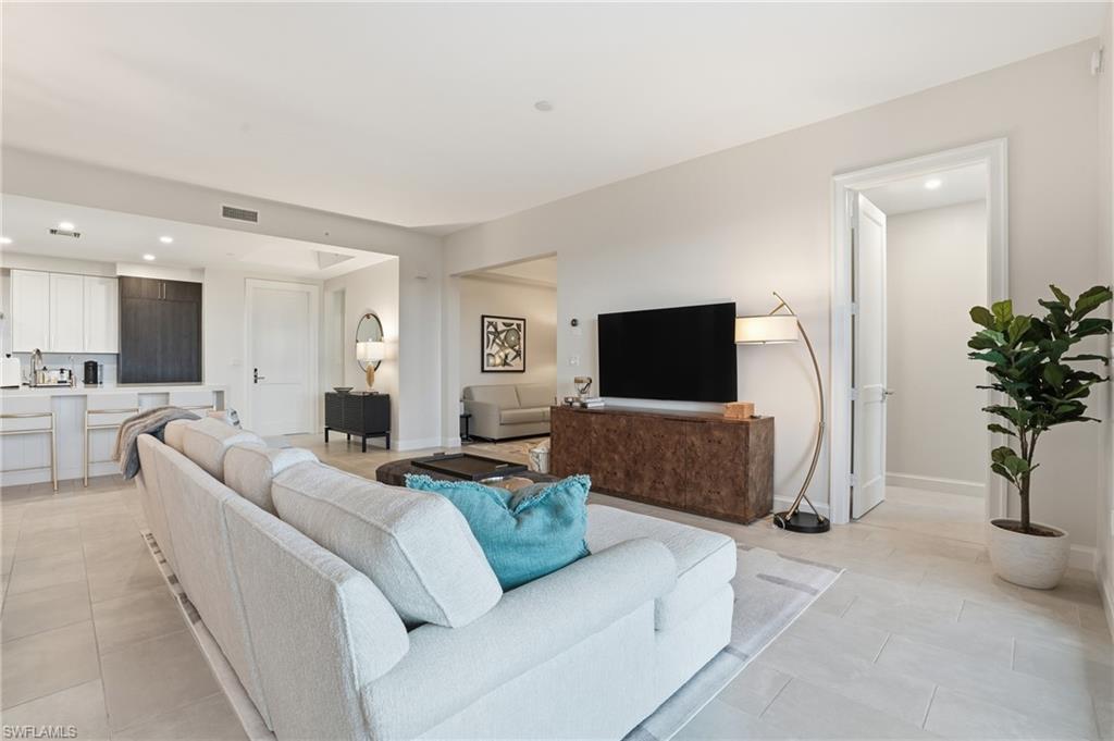 1125 Central Avenue, Unit 469 Naples, FL 34102 - Photo 8 of 38 a living room with furniture and a flat screen tv
