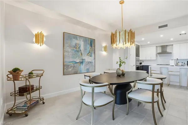 a view of a a dining room with furniture window and wooden floor