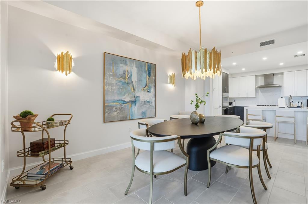 1125 Central Avenue, Unit 469 Naples, FL 34102 - Photo 9 of 38 a view of a a dining room with furniture window and wooden floor