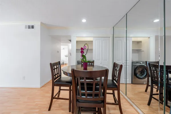 a view of a dining room with furniture and wooden floor