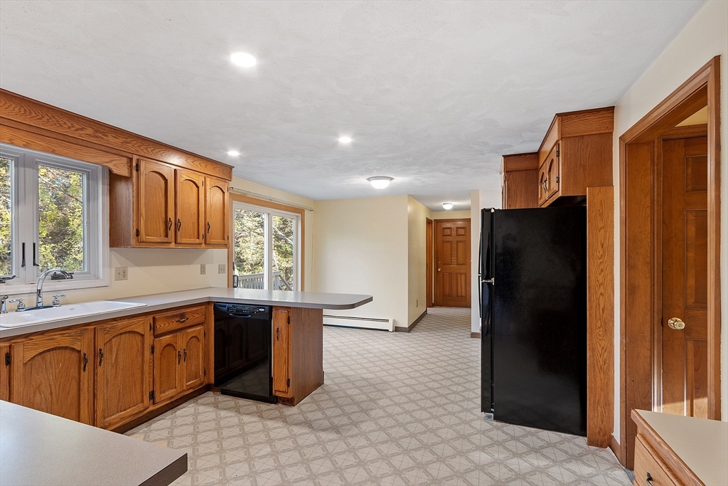 69 Blanchard Street Andover, MA 01810 - Photo 12 of 29 a kitchen with stainless steel appliances granite countertop a refrigerator and a sink