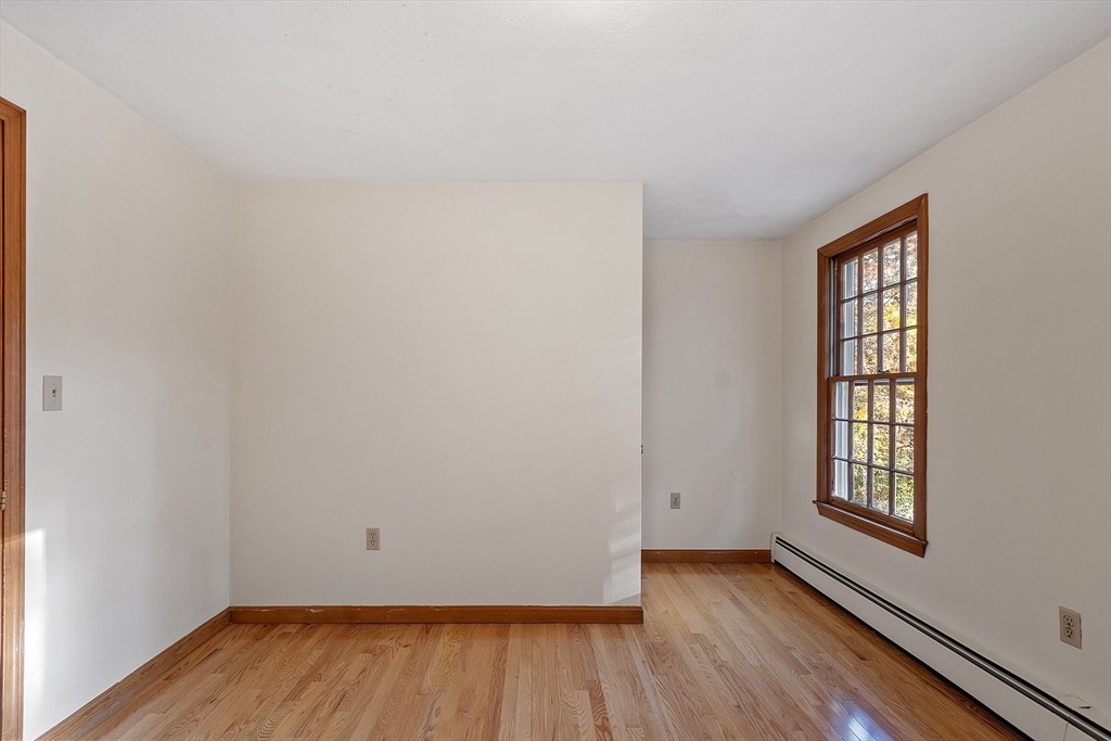 69 Blanchard Street Andover, MA 01810 - Photo 15 of 29 an empty room with wooden floor and windows