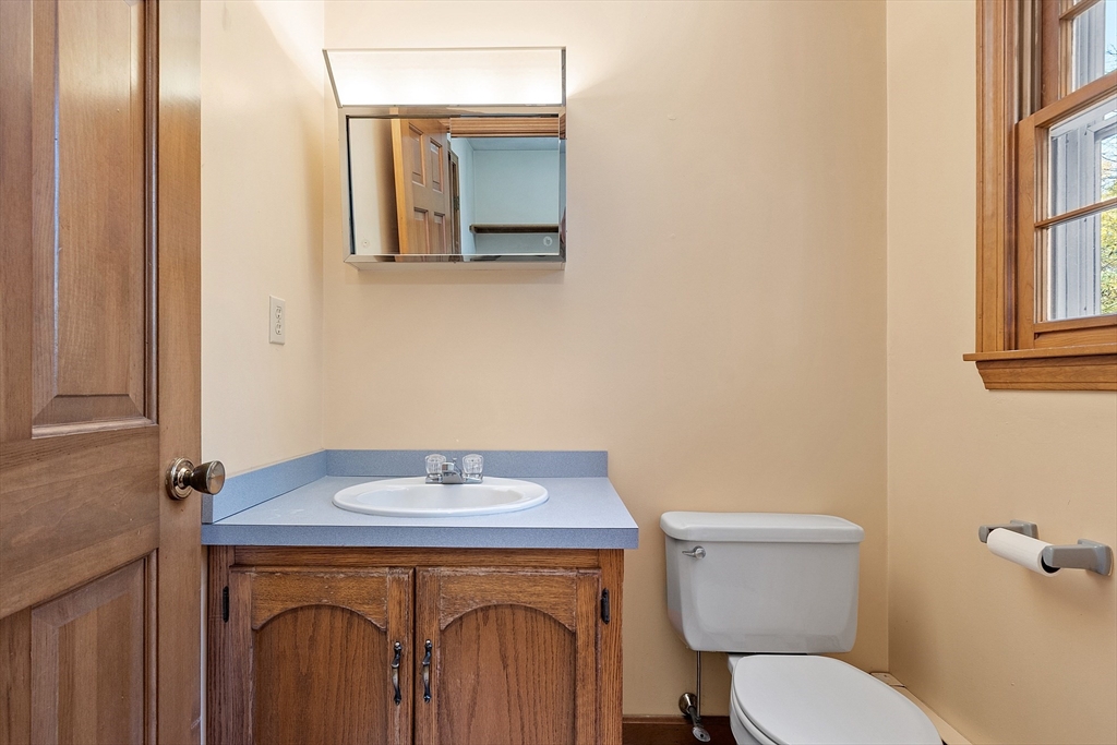 69 Blanchard Street Andover, MA 01810 - Photo 9 of 29 a bathroom with a sink a toilet and a mirror