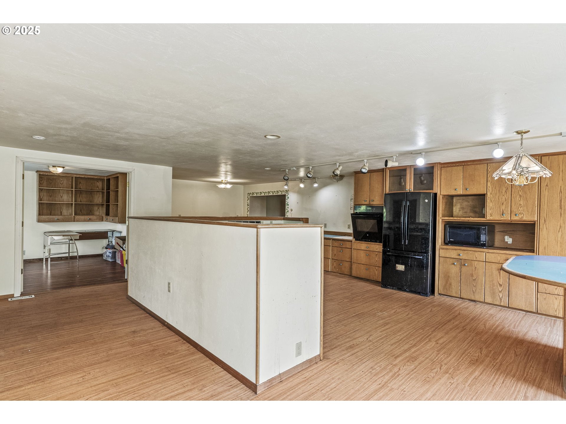 135 Westside Highway Vader, WA 98593 - Photo 19 of 31 a kitchen with stainless steel appliances kitchen island granite countertop a refrigerator oven a sink with dishwasher and white cabinets