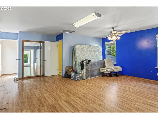 a view of empty room with a fireplace and wooden floor