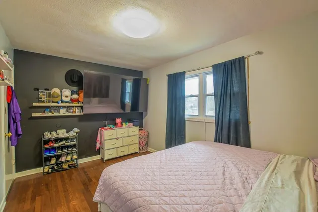 a bedroom with a bed and dresser