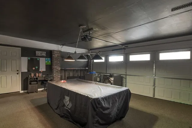 a kitchen with a sink a counter and chairs
